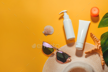 he beach in summer and on vacation. Hat, sunglasses, cosmetics, cream and lotion with SPF and UV protection. Background concept of skin protection from the sun and photoaging