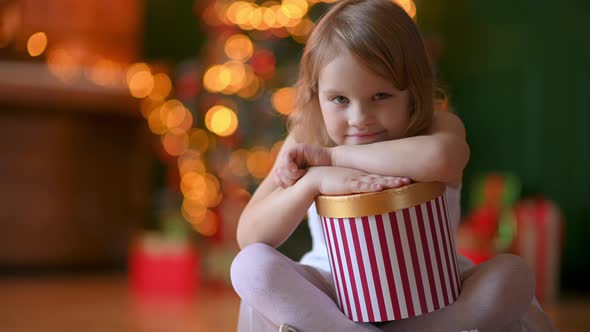 Happy Cute Girl with a gift in her hands