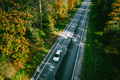 Aerial view of autumn road with colorful trees in woods - PhotoDune Item for Sale