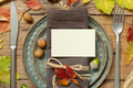 Autumn rustic table setting with place card between colorful leaves and berries top view, mockup - PhotoDune Item for Sale