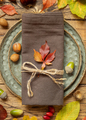 Autumn rustic table setting between leaves and berries on vintage wooden table top view - PhotoDune Item for Sale