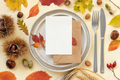 Autumn table place with colorful leaves and vertical blank card top view, mockup - PhotoDune Item for Sale