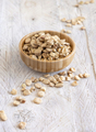 Bowl of raw dry Grass pea close up on wooden table. Legumes known in Italy as Cicerchia - PhotoDune Item for Sale
