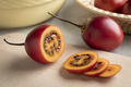 Fresh ripe sliced tamarillo close up on a cutting board - PhotoDune Item for Sale