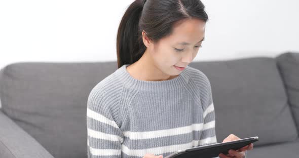 Woman use of tablet computer at home