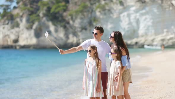 Young Beautiful Family Taking Selfie Portrait on the Beach