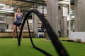 sporty woman training by shaking the ropes - PhotoDune Item for Sale