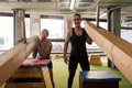 sporty woman and man pose on a training machine - PhotoDune Item for Sale