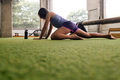 sporty woman stretching and massaging her muscles - PhotoDune Item for Sale