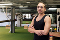 young trainer poses with arms crossed in his gym - PhotoDune Item for Sale