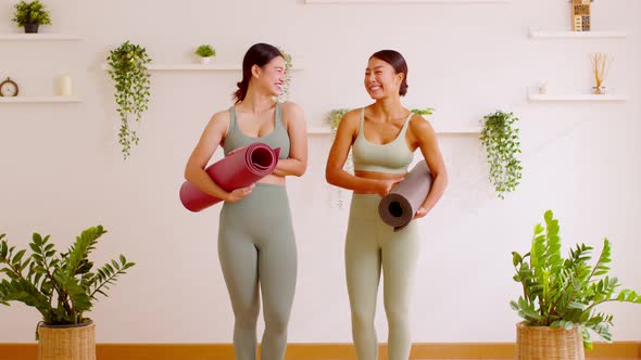 Happy Couple Asian young woman hold yoga mat smile and laughing together ready to exercise yoga priv