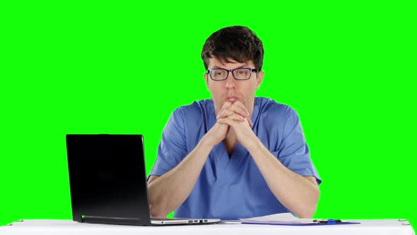 Young Worried Doctor Holding His Head. Green Screen