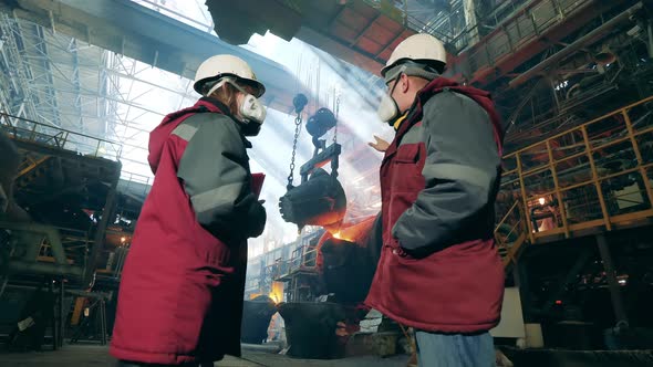 Steel Mill Employees are Discussing Metal Casting