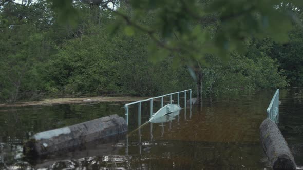 Crossing flooded walk bridge along river side walk