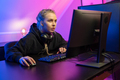 Focused Professional E-sport Gamer Girl in Hoody Playing Online Video Game on PC - PhotoDune Item for Sale