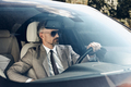 Confident mature man in formalwear and eyeglasses driving a car - PhotoDune Item for Sale