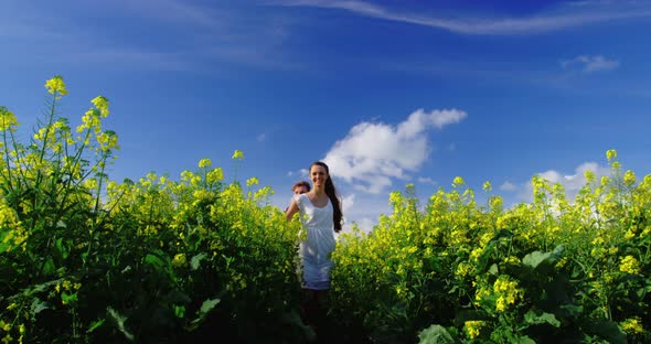 Romantic couple holding hands while walking in field