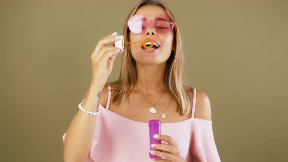 Young Girl in Sunglasses and Pink Blouse