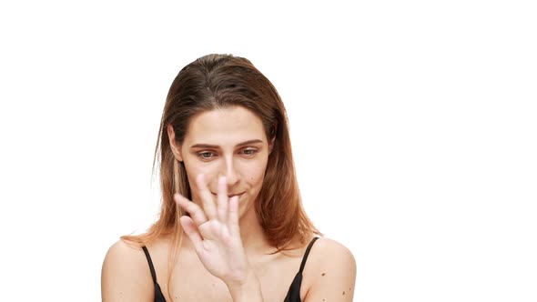 Displeased Young Beautiful Girl Beckoning Gesturing Over White Background