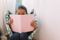 sweet happy little girl reading book - PhotoDune Item for Sale