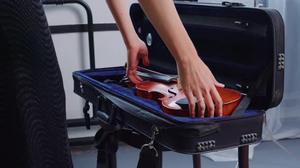 Female Hands Take Violin Bow From Fiddle Case