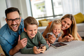 Device technology family online education concept. Happy family with digital devices at home - PhotoDune Item for Sale