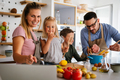 Happy family preparing healthy food together in kitchen - PhotoDune Item for Sale
