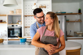 Attractive couple is cooking together organic healthy food in kitchen - PhotoDune Item for Sale