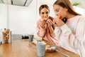 White mother and daughter having breakfast together in kitchen - PhotoDune Item for Sale