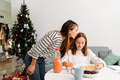 White mother kissing her daughter while having breakfast - PhotoDune Item for Sale