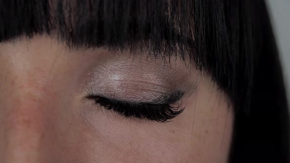 Woman Opening Eye Footage Closeup Footage on One Female Dark Eye