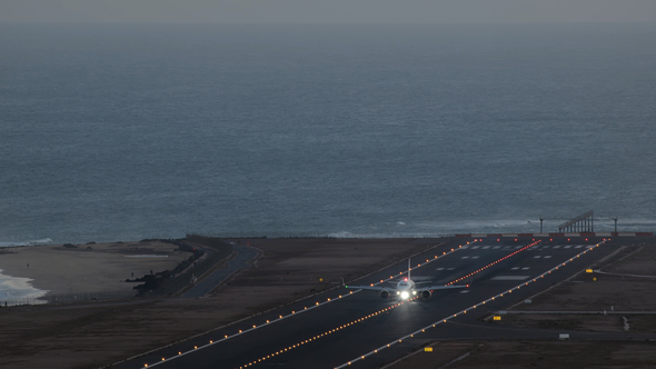 Airplane Landing on the Runway at Sunset