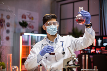 ding flask with lab glassware and test tubes in chemical laboratory background, science laboratory research and development medicines.