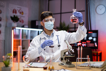 ding flask with lab glassware and test tubes in chemical laboratory background, science laboratory research and development medicines.