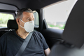 Senior in his 70s sitting at the back of car wearing a face mask - PhotoDune Item for Sale