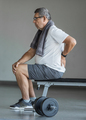 Active senior in gym with back pain - PhotoDune Item for Sale