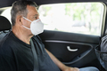 Senior in his 70s sitting at the back of car wearing a face mask - PhotoDune Item for Sale