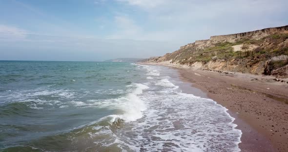 Tropical Beach Video, Aerial Bird Eye View of Blue Foaming Ocean Waves Crushing Against the Coast