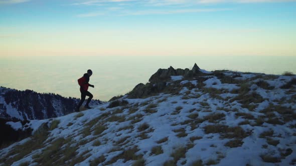 Man Running at the Mountain with Snow