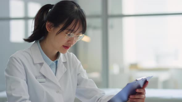 Asian Female Doctor Giving Consultation to Woman