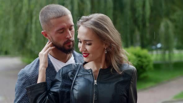 Charming Woman in Embrace of Her Boyfriend in Rain Loving Couple is Hugging Outdoors