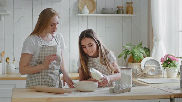 Adult Mother Caucasian Woman Housewife Teaches Helping Little Daughter Child Girl to Cook Dish Small