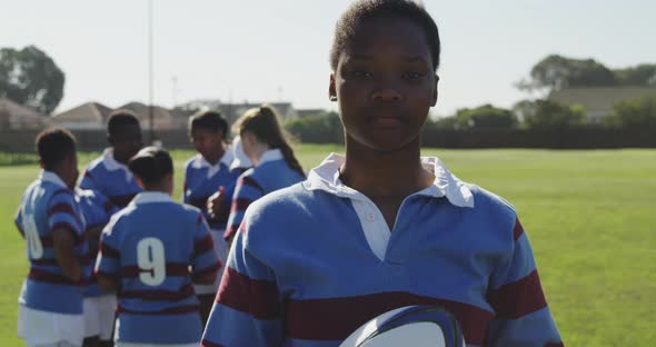 Portrait of young adult female rugby player on a rugby pitch