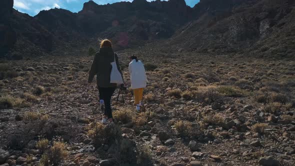 A Group of Tourists Walk Through the Mountains of Solidified Lava in the Teide Volcano National Park