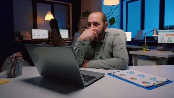 Exhausted Businessman Discussing Marketing Deadline Project with Remote Employee