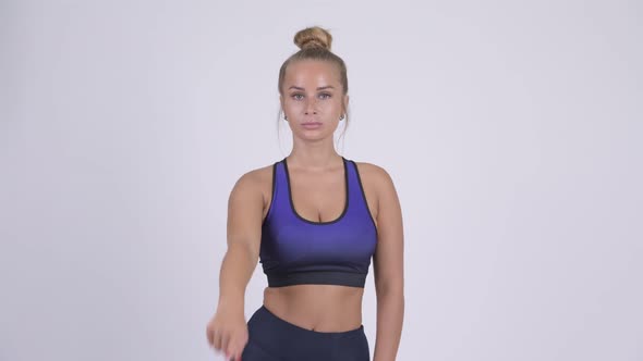 Young Beautiful Blonde Woman Pointing To Camera Ready for Gym