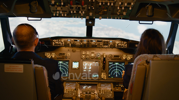 Pilot and woman copilot fixing altitude and longitude on dashboard