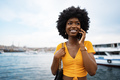 Happy young african american young woman talking with cellphone in city - PhotoDune Item for Sale