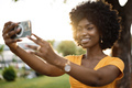 Portrait of a young afro american woman taking a selfie outdoor - PhotoDune Item for Sale