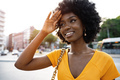 Portrait of a young african american woman smiling standing at the city. - PhotoDune Item for Sale